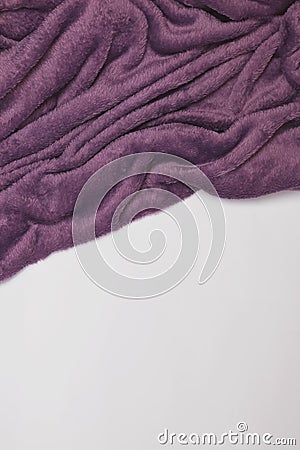 Purple soft blanket on the white bed, top view. Stock Photo