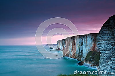 Purple sunrise over Atlantic ocean and cliffs Stock Photo