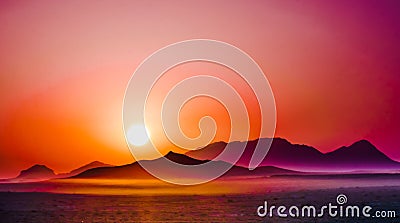 Purple sunrise over the mountains in the desert Stock Photo