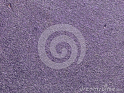 Purple texture of the soft rubber surface of the safe cover of the sports playground for workout made of pressed fine rubber. The Stock Photo