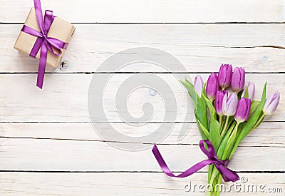 Purple tulips and gift box over wooden table Stock Photo