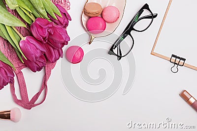 Purple tulips, macarons and sylish feminine accessories on the white table Stock Photo