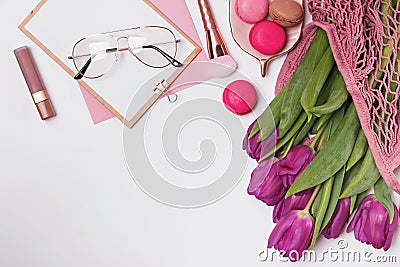 Purple tulips, macarons and sylish feminine accessories on the white table Stock Photo