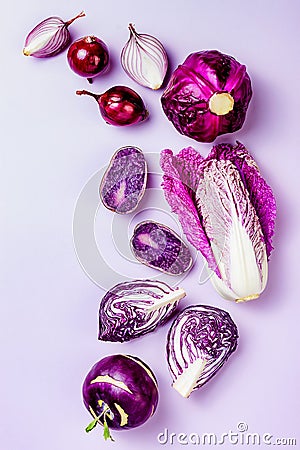 Purple vegetables on pastel color background. Minimal concept. Plant based vegan or vegetarian cooking. Clean eating food Stock Photo