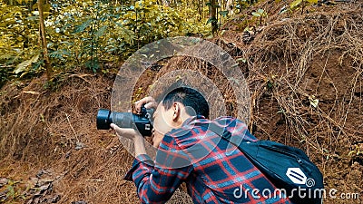 purworejo-indonesia,13 Nov 2019:a photographer captures images in the forest Editorial Stock Photo