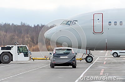 Push back tow tractor aircraft. Airfield services in the car waiting to miss the plane at the intersection Stock Photo