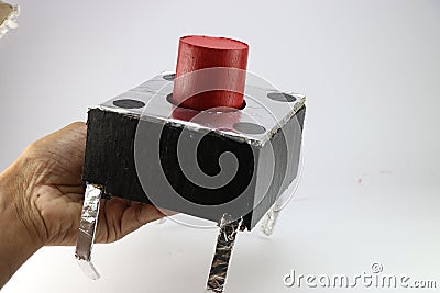 Push button is usually small in size replicated to a large sized switch using cardboard and aluminum foil held in the hand Stock Photo