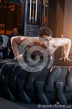 Push up on a tire cross fit training Stock Photo