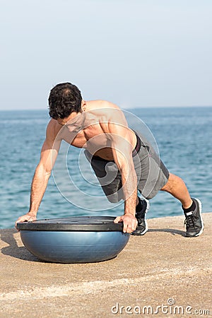 Push ups on a bosu balance Stock Photo