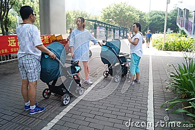 Pushing baby carriages on the sidewalk in Shenzhen, China Editorial Stock Photo