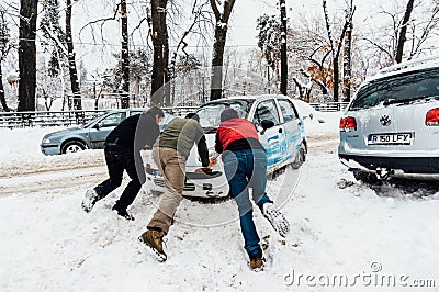 Pushing car in snow, Bucharest, Romania Editorial Stock Photo