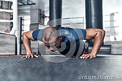 Pushing hard. Handsome young African man in sport clothing doing Stock Photo
