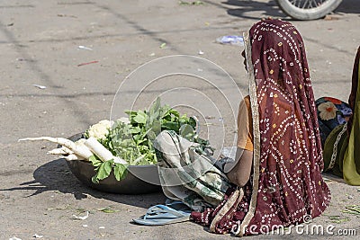 Food trader selling vegetables in street market. Pushkar, Rajasthan, India Editorial Stock Photo