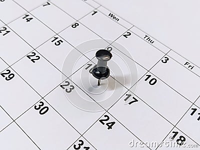 Pushpin stuck into calendar, event reminder Stock Photo
