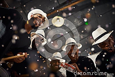They always put on a dazzling performance. Portrait of a group of musical performers playing drums together. Stock Photo