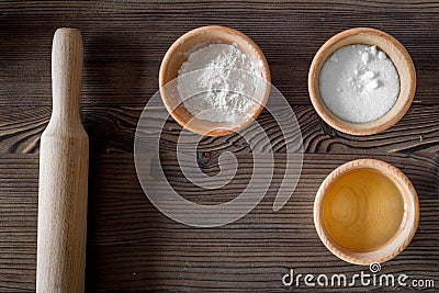 Put the dough. Flour, salt, oil and rolling pin on dark wooden table background top view copyspace Stock Photo