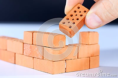 Put in the last brick Stock Photo