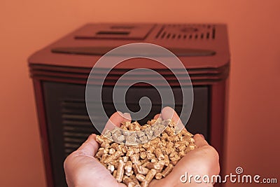 put the methane pellet granules inside the pellet stove Stock Photo