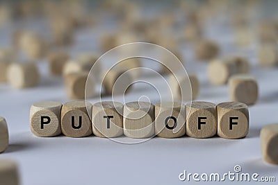 Put off - cube with letters, sign with wooden cubes Stock Photo