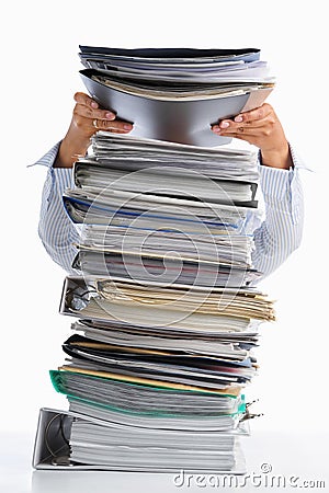 Put paper into high pile paperwork Stock Photo