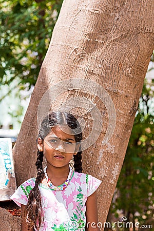 PUTTAPARTHI, ANDHRA PRADESH, INDIA - JULY 9, 2017: Portrait of Indian cute girl on the street. Close-up. Vertical. Editorial Stock Photo