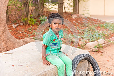 PUTTAPARTHI, ANDHRA PRADESH, INDIA - JULY 9, 2017: Portrait of Indian cute girl on the street. Copy space for text. Editorial Stock Photo