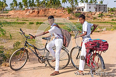 PUTTAPARTHI, ANDHRA PRADESH, INDIA - JULY 9, 2017: Two Indian boys on bicycles. Copy space for text. Editorial Stock Photo