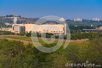 PUTTAPARTHI, ANDHRA PRADESH - INDIA - NOVEMBER 09, 2016: Remote view of the building of Puttaparthi with a sculpture of the Hindu Editorial Stock Photo