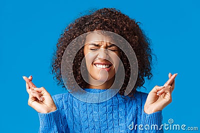 Putting all efforts in pray for wish come true. Hopeful cute african-american woman desire dream fulfill, close eyes and Stock Photo