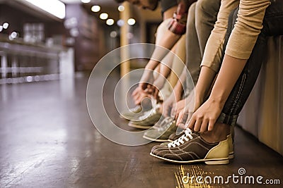 Putting on bowling shoes Stock Photo