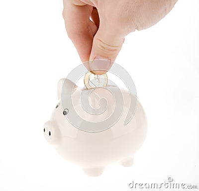 Putting coin into piggy bank isolated Stock Photo