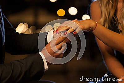 Putting on an engagement ring Stock Photo