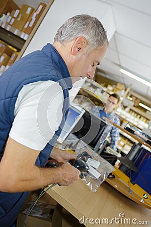 Putting item in plastic Stock Photo