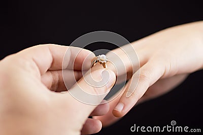 Putting a ring on girl's hand Stock Photo