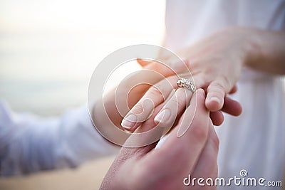 Putting ring on hand Stock Photo