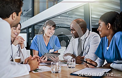 Putting their patients wellness on the agenda. a group of doctors having a meeting in a hospital. Stock Photo