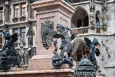 Putto fighting a serpent representing heresy - Mariensaule Sculpture at Marienplatz Square - Munich, Bavaria, Germany Editorial Stock Photo