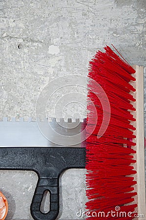 Putty knife and brush broom. spatula and measuring balance level on damaged wall background. repair and construction. repair tool Stock Photo