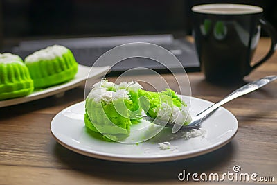 Putu ayu cake slices on a spoon on a laptop background looks blurry Stock Photo