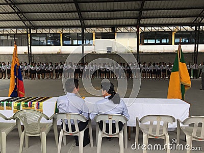 Puyo, Ecuador, 26-9-2011: two school teachers watching the bandera, an official day at the ecuadorian schools Editorial Stock Photo