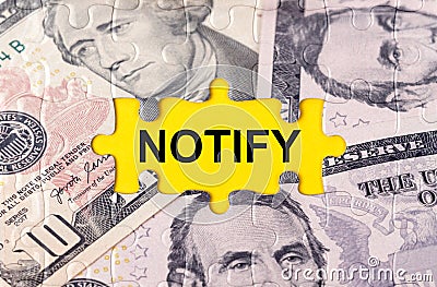 Puzzle with the image of dollars in the center of the inscription -NOTIFY Stock Photo