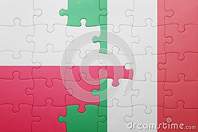 Puzzle with the national flag of italy and poland Stock Photo