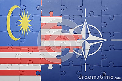 Puzzle with the national flag of malaysia and nato Stock Photo