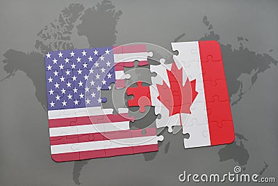 Puzzle with the national flag of united states of america and canada on a world map background Stock Photo