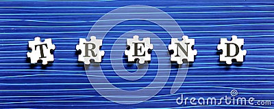 Puzzle piece with TREND text on a blue background Stock Photo