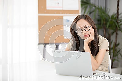 Asian woman thinking hard concerned about online problem. Stock Photo