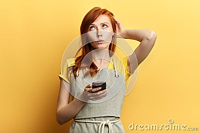 Puzzled girl doesn`t know what to write to her friend, Stock Photo