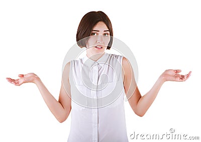 A puzzled model in an elegant blouse isolated on the white background. Shocked young business woman. A girl shrugs shoulders. Stock Photo