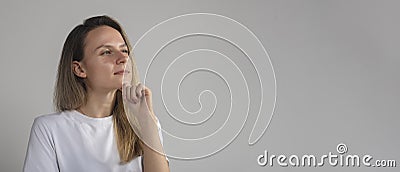Puzzled perplexed young woman with distrustful face isolated on grey studio wall, unbelieving suspicious girl looking at camera Stock Photo