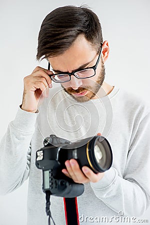 Puzzled photographer with camera Stock Photo